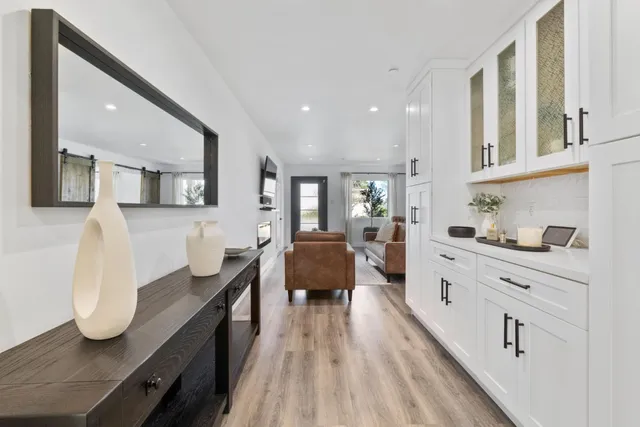 a large white kitchen with cabinets
