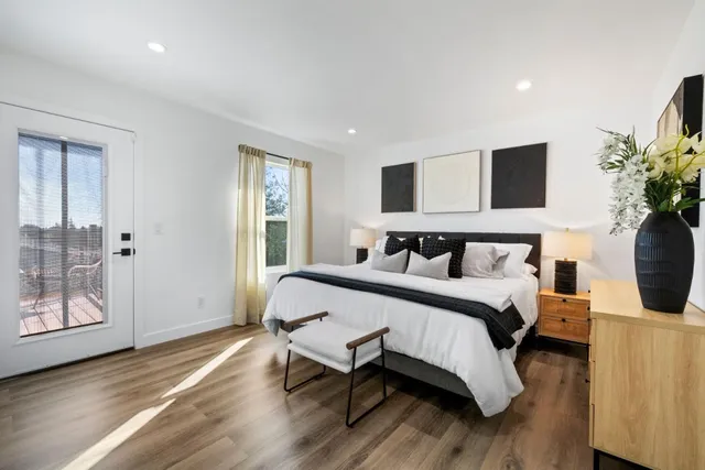 a bedroom with bed and wooden floor