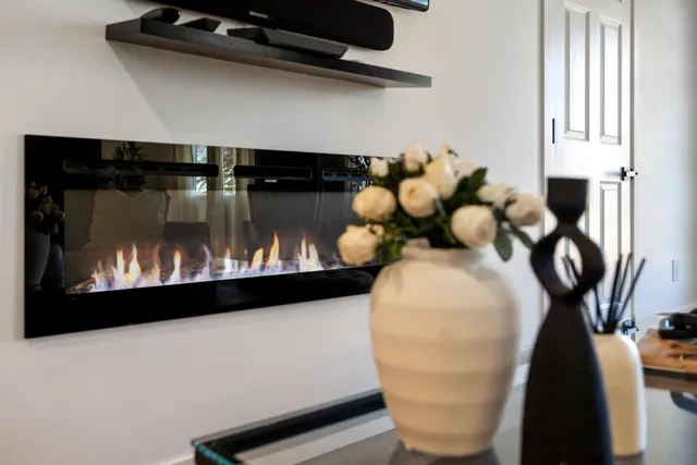 a view of a living room with furniture and a refrigerator