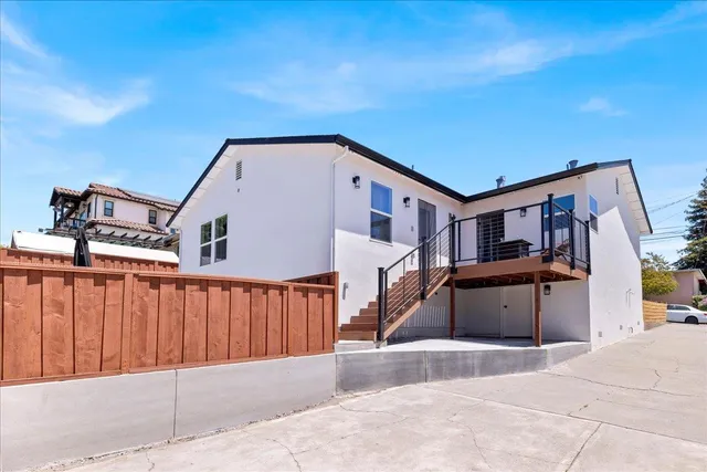 a view of a patio with table and chairs potted plants and a palm tree