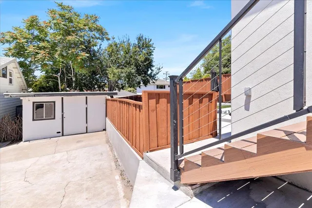 a view of a patio with couches table and chairs and potted plants