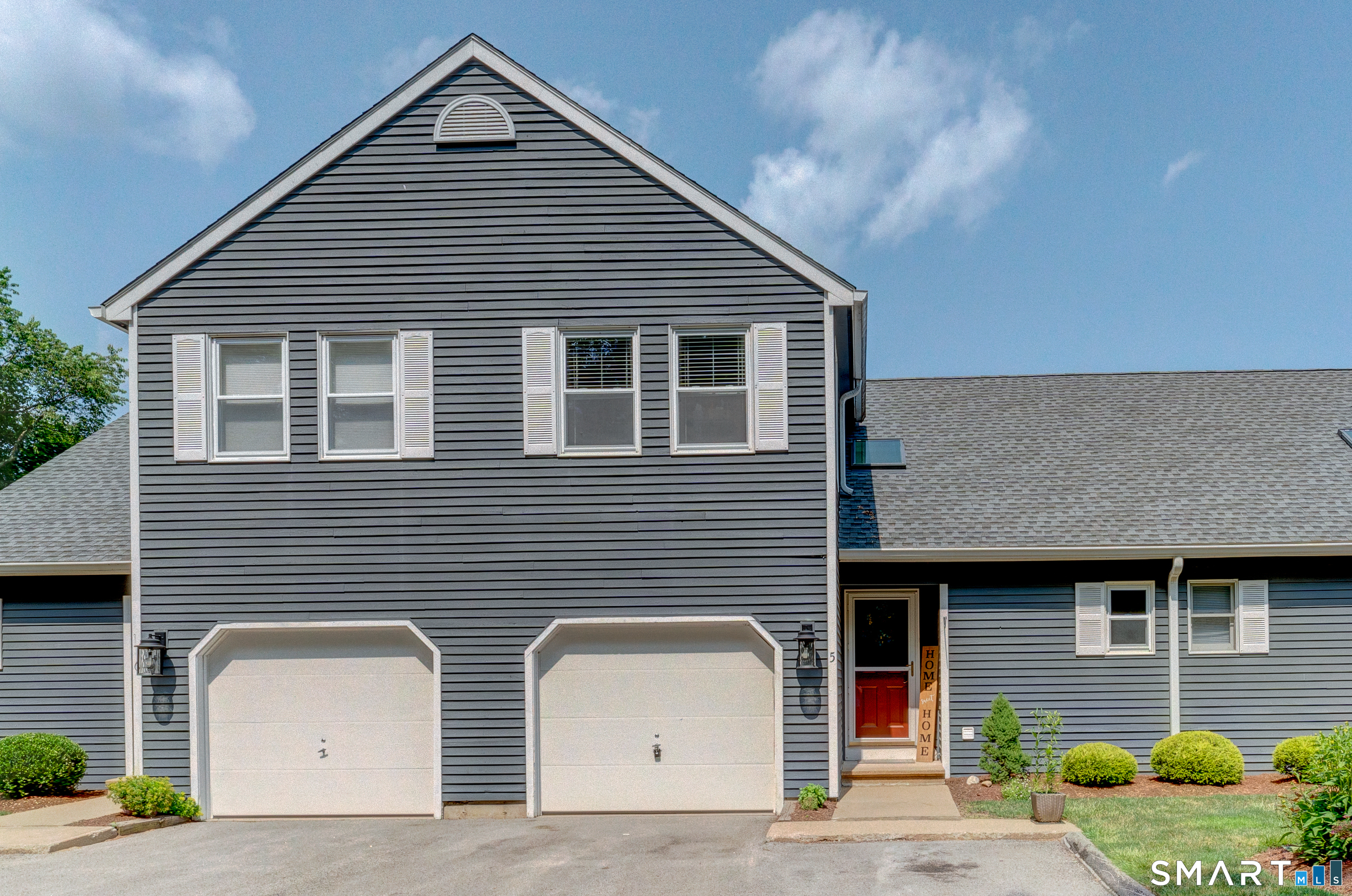 a front view of a house with garage