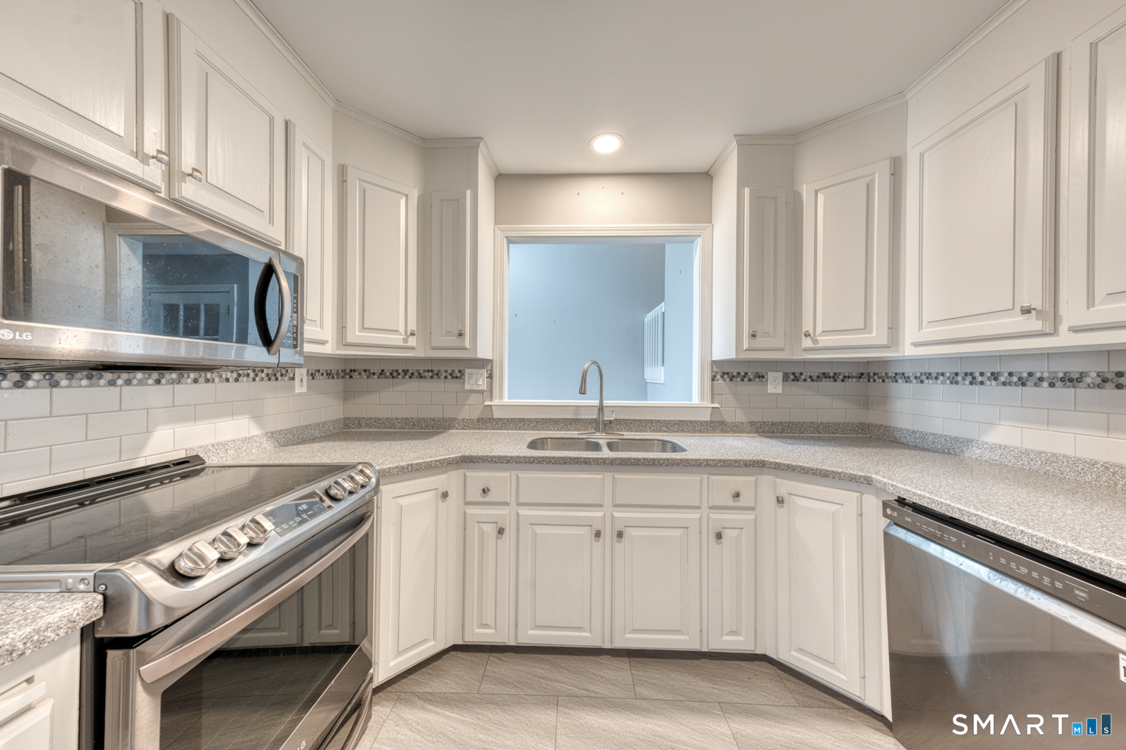 5 Vicki Lane, Unit 5 Colchester, CT 06415 - Photo 16 of 42 a kitchen with granite countertop white cabinets and stainless steel appliances