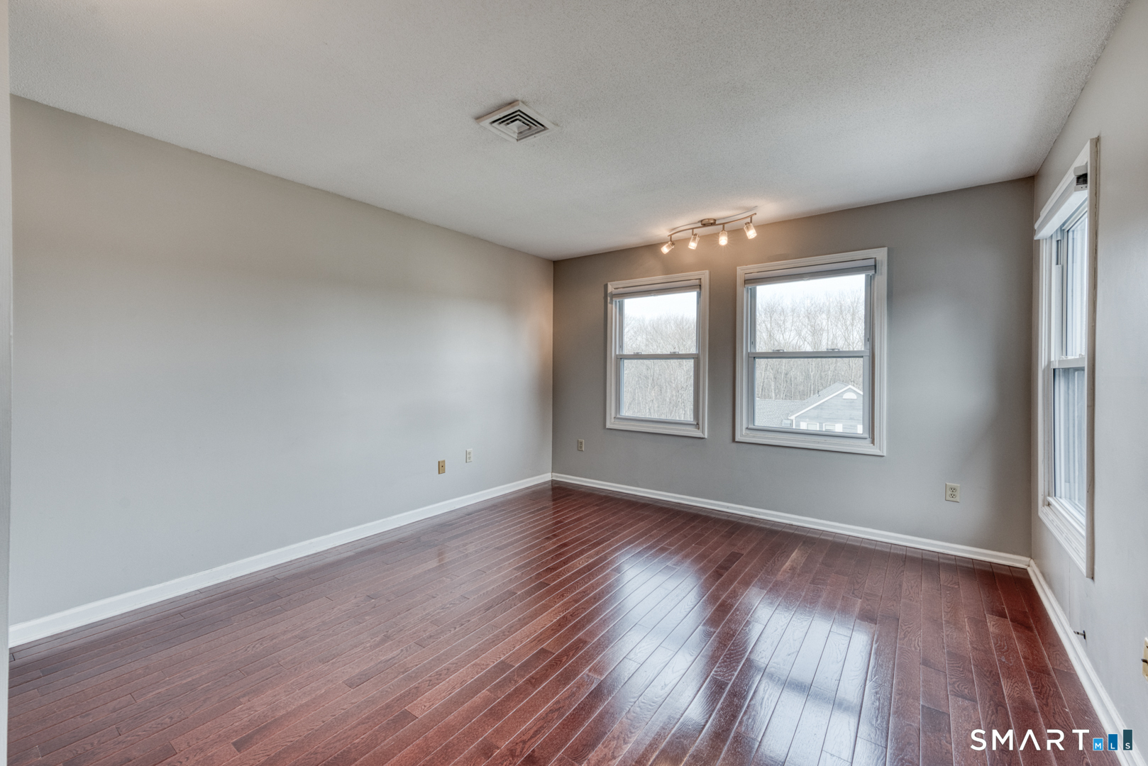 5 Vicki Lane, Unit 5 Colchester, CT 06415 - Photo 24 of 42 an empty room with wooden floor and windows