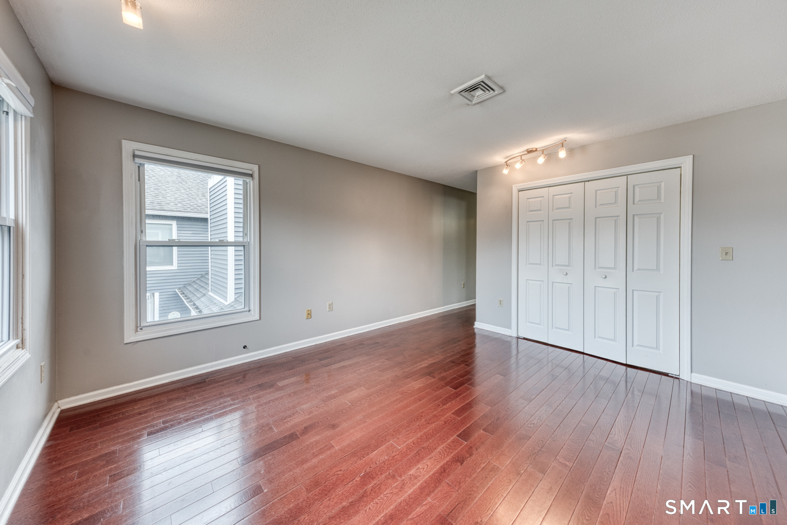 5 Vicki Lane, Unit 5 Colchester, CT 06415 - Photo 26 of 42 a view of an empty room with wooden floor and a window