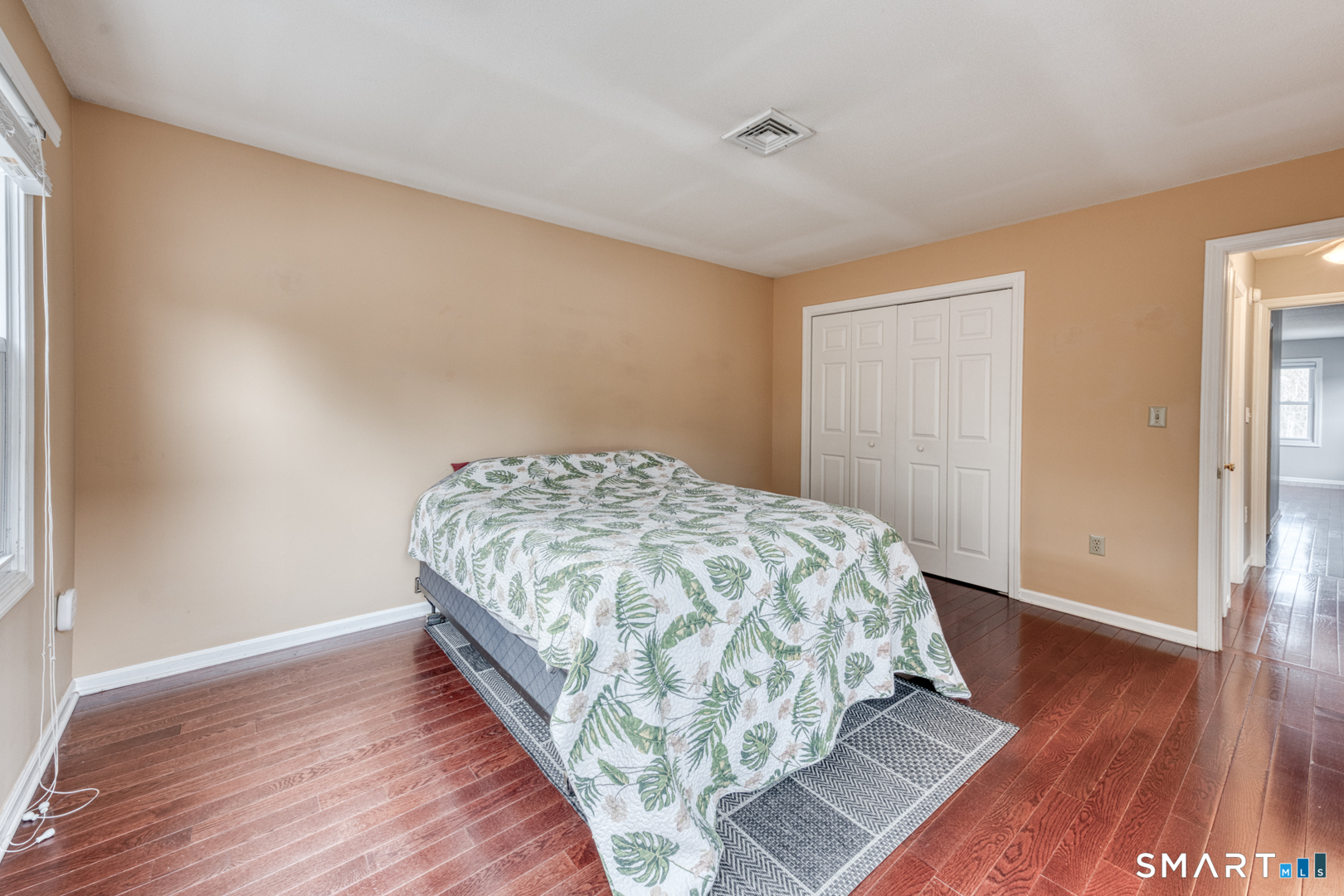 5 Vicki Lane, Unit 5 Colchester, CT 06415 - Photo 29 of 42 a bedroom with a bed and wooden floor