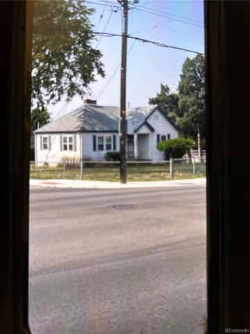 a view of a house with a big yard and large trees
