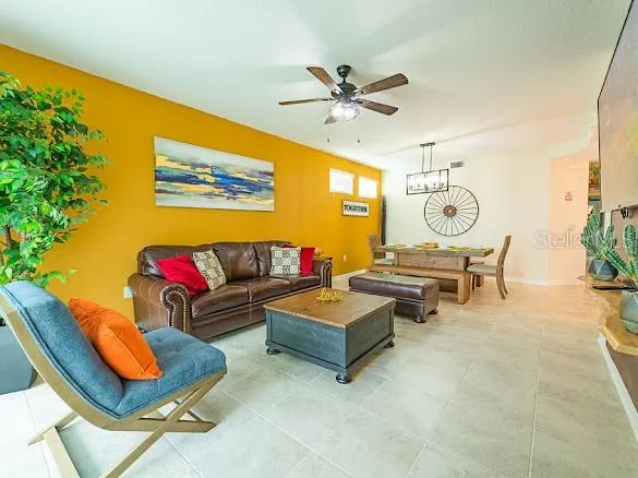 a dining room with wooden floor a chandelier a wooden table and chairs