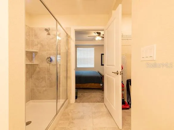 a bathroom with a shower and a glass door