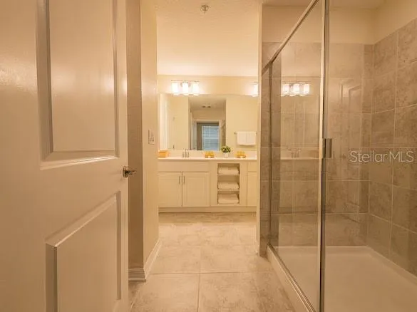 a bathroom with a shower and a sink