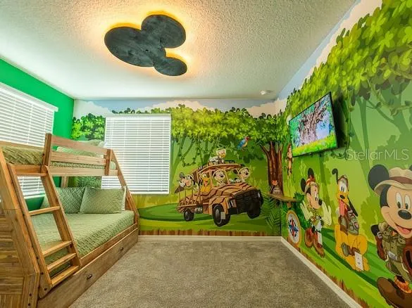 a bedroom with furniture and a large window