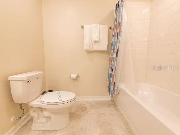 a bedroom with a bed and ceiling fan