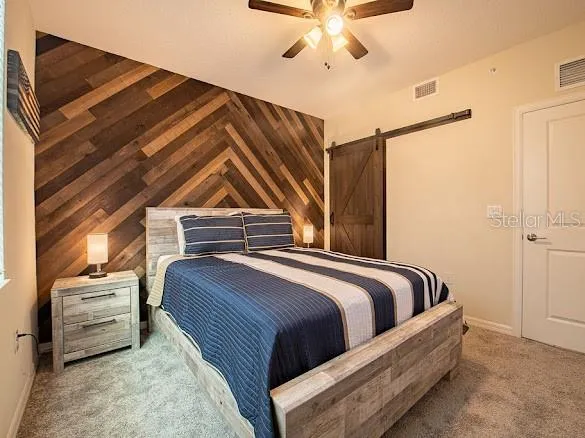 a spacious bedroom with a bed and a potted plant