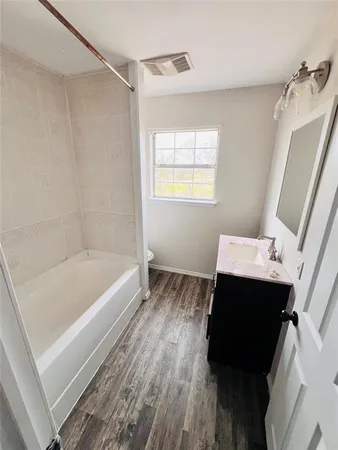 a bathroom with a bathtub and a sink