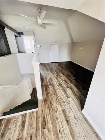 a view of a living room with a bed and a rug