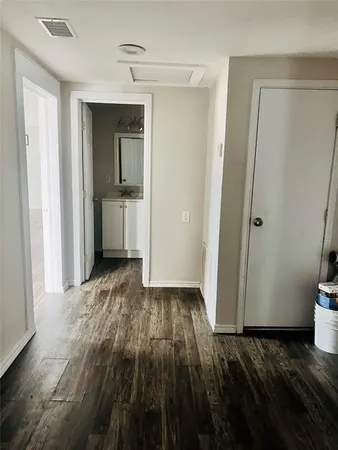 a view of a room with wooden floor and a sink