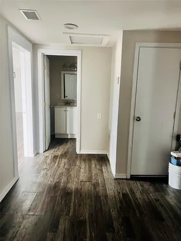 a view of a room with wooden floor and a sink