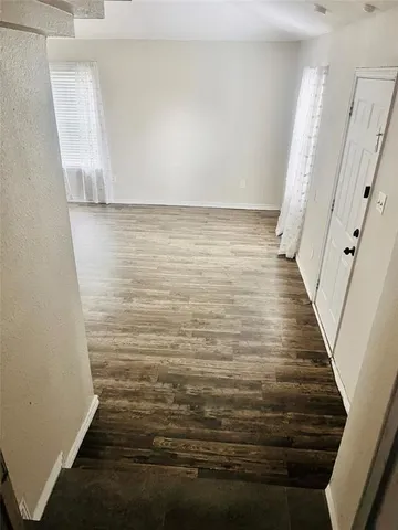 a view of a hallway view with wooden floor and furniture