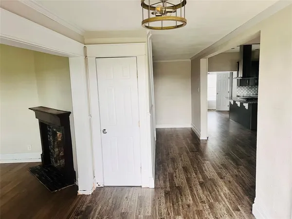 an empty room with wooden floor and a window