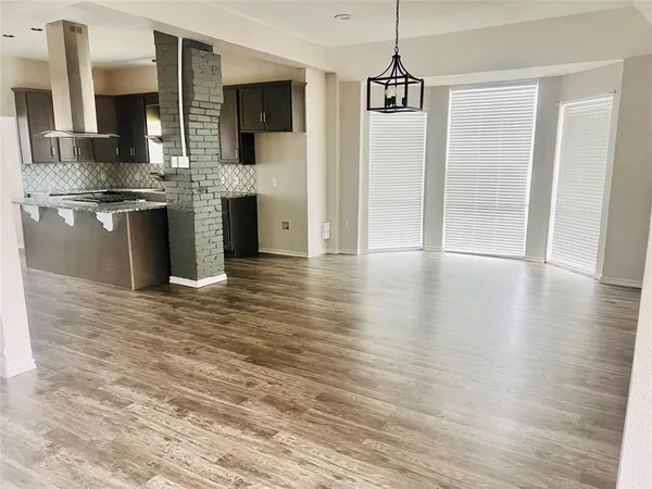 a kitchen view with stainless steel appliances a refrigerator and a stove top oven