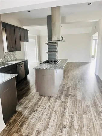 a kitchen with a sink and a stove top oven