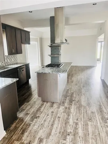 a kitchen with a sink and a stove top oven