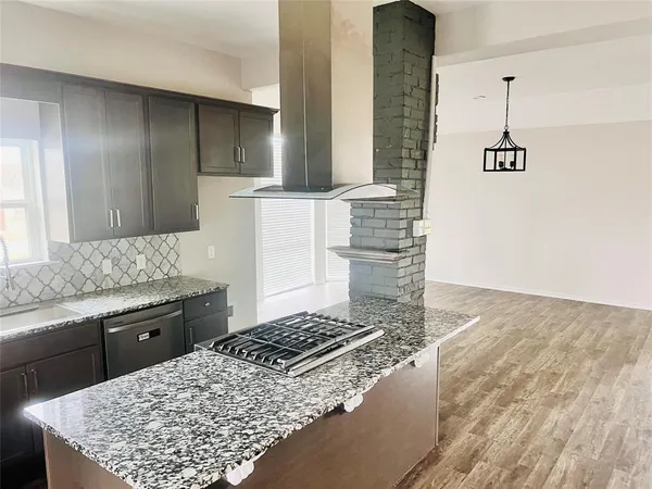 a kitchen with a stove and a sink
