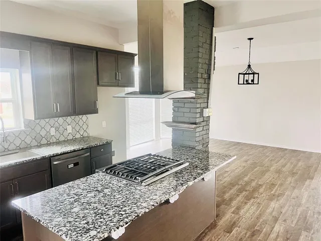 a kitchen with a stove and a sink