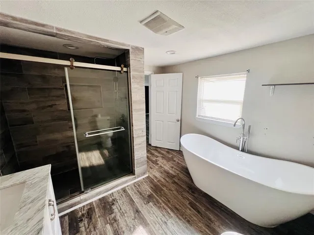 a bathroom with a bathtub and toilet
