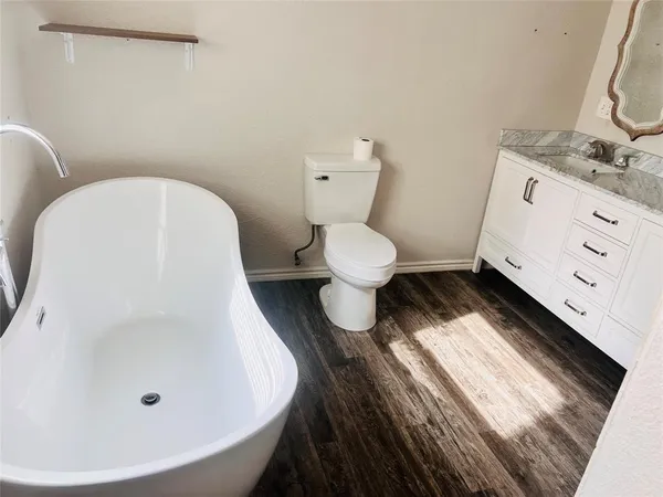 a white toilet sitting next to a bathroom sink