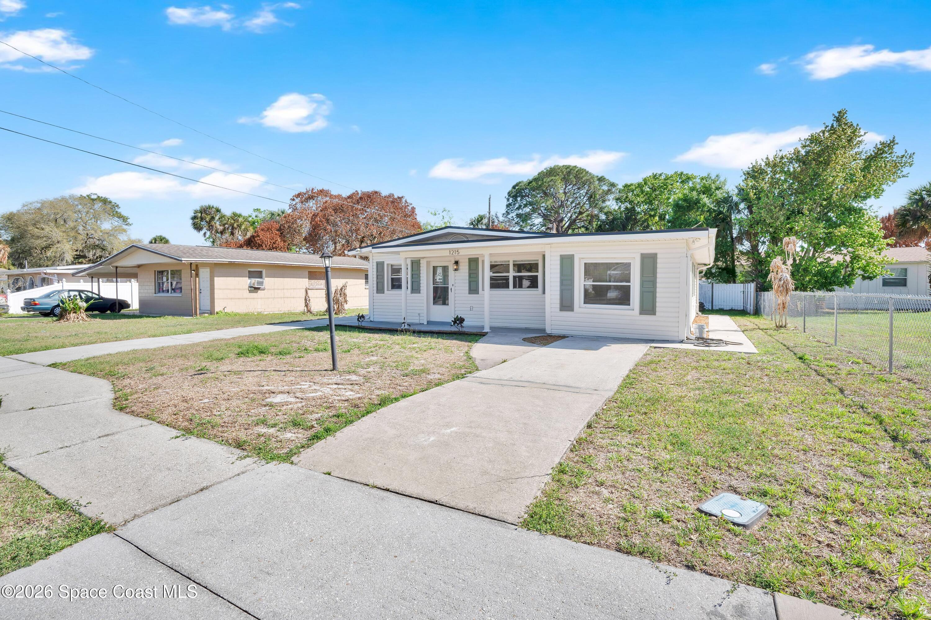 1215 Counts Street Cocoa, FL 32922 - Photo 2 of 25 front view of a house with a yard