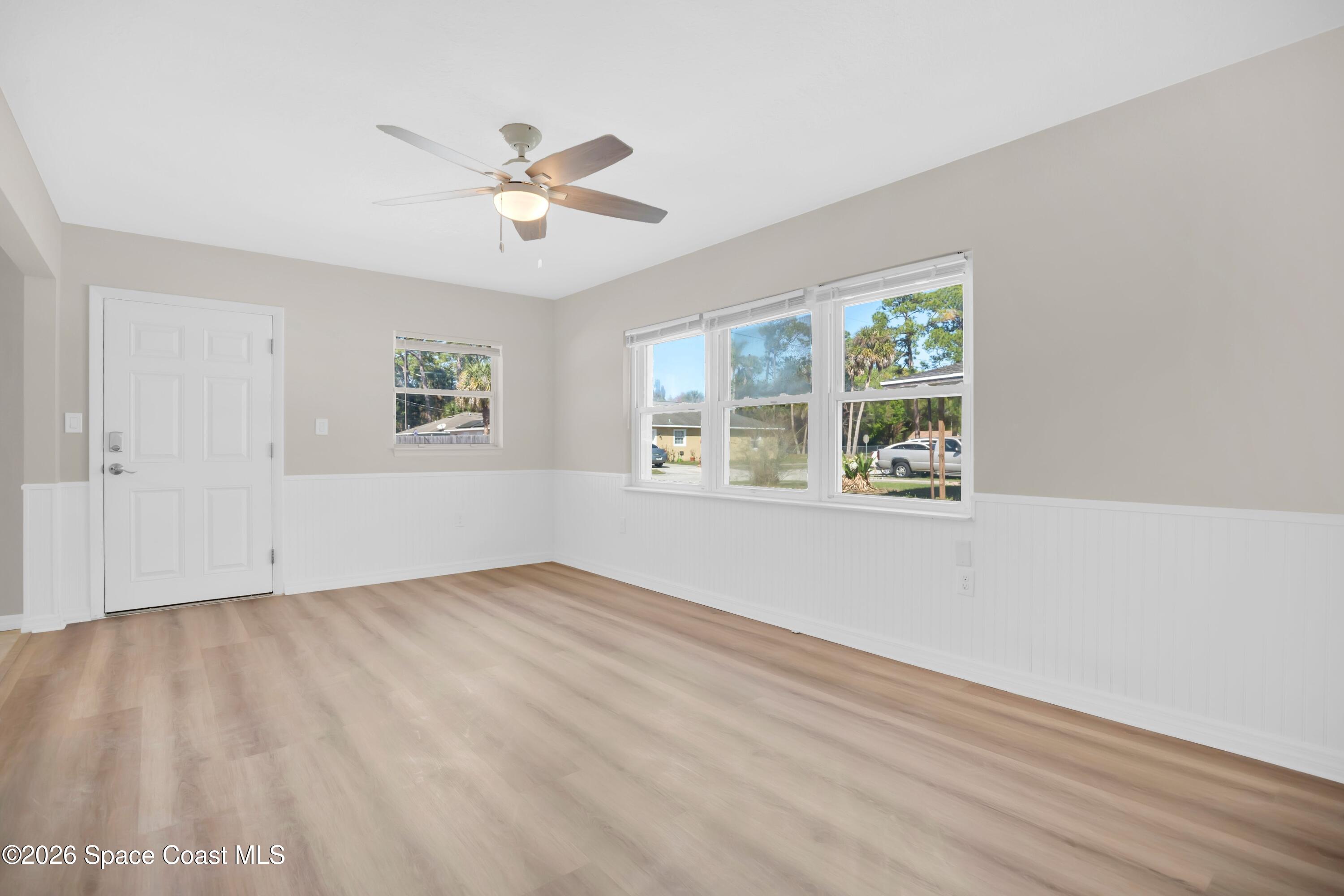 1215 Counts Street Cocoa, FL 32922 - Photo 4 of 25 wooden floor in an empty room with a window