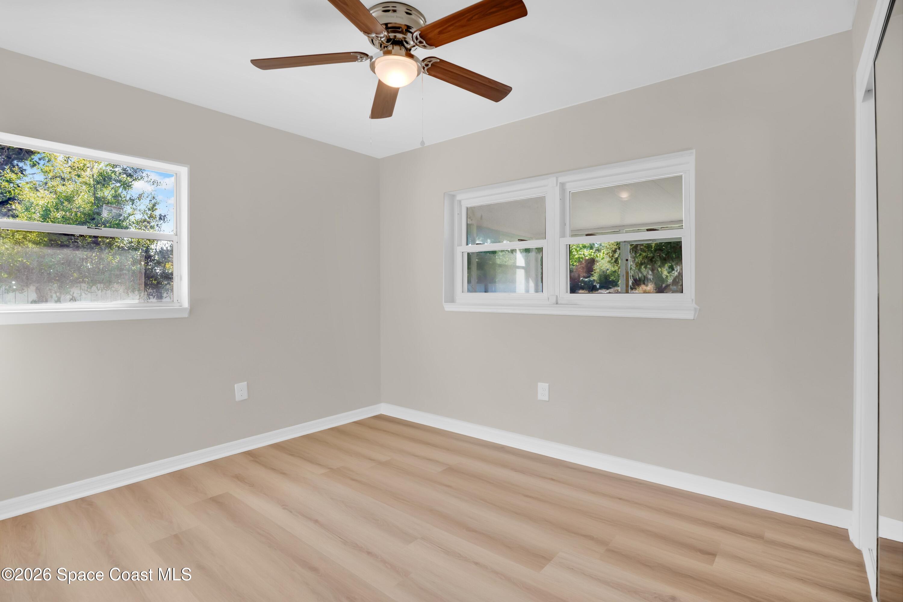1215 Counts Street Cocoa, FL 32922 - Photo 10 of 25 a view of an empty room with wooden floor and a window