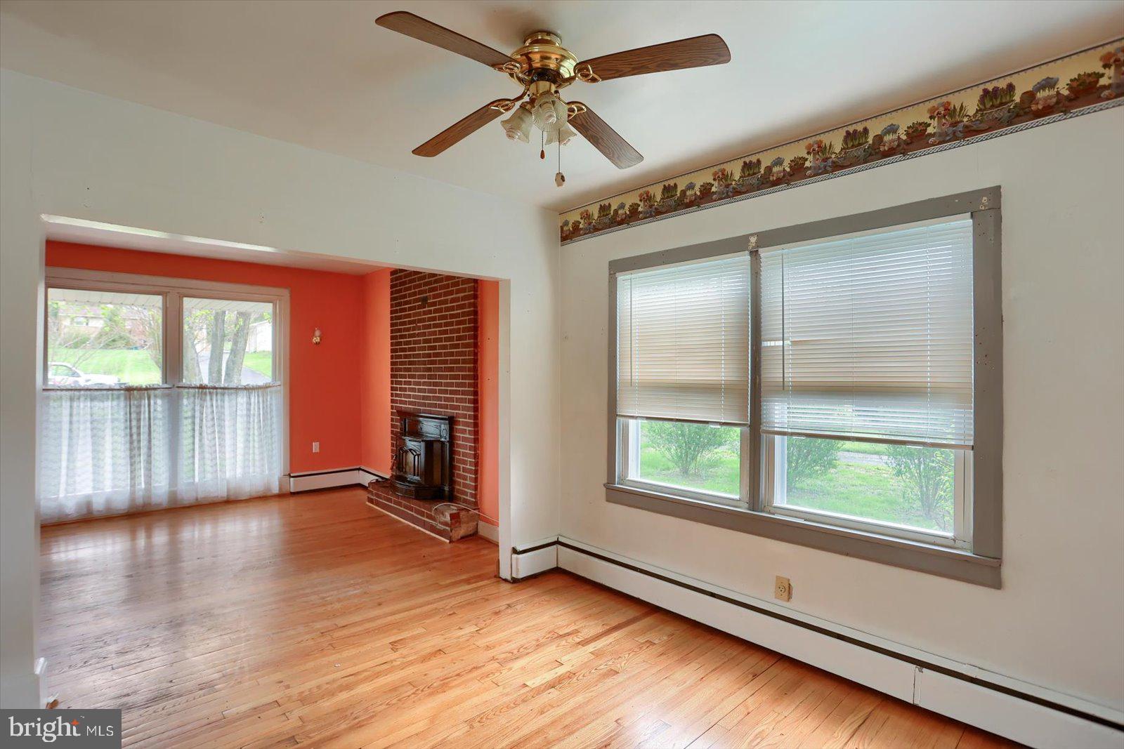 2301 Snow Road Edgewood, MD 21040 - Photo 12 of 41 an empty room with wooden floor fan and windows