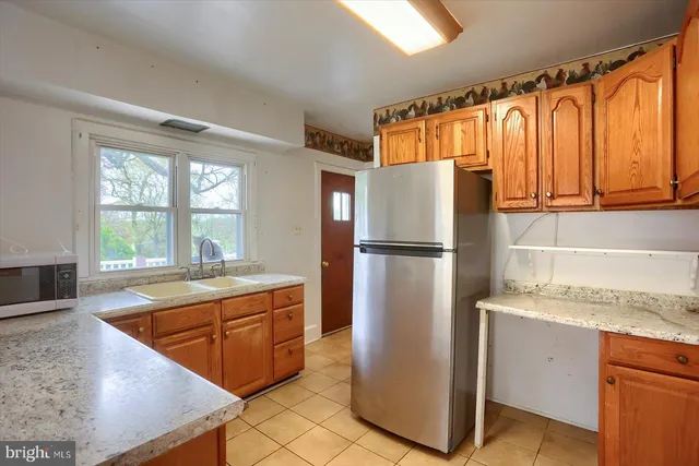 a kitchen with granite countertop a sink and a window