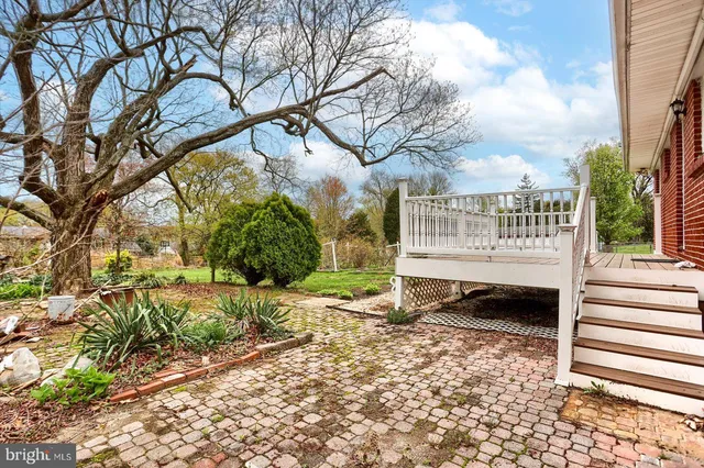 a view of a house with backyard sitting area and garden