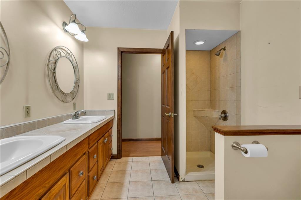1601 Cottage Avenue Conway, PA 15027 - Photo 23 of 41 a spacious bathroom with a granite countertop sink mirror and a bathtub