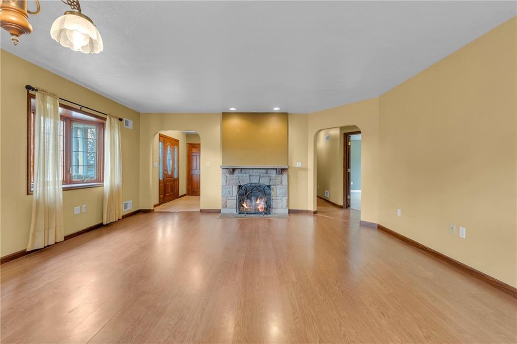1601 Cottage Avenue Conway, PA 15027 - Photo 8 of 41 an empty room with wooden floor and fireplace