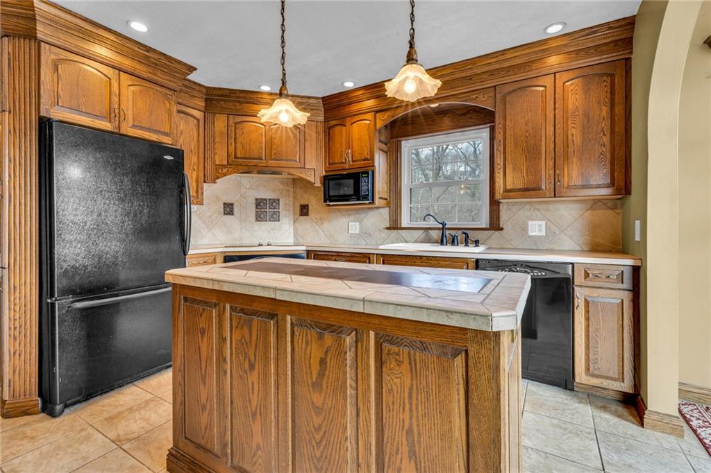 1601 Cottage Avenue Conway, PA 15027 - Photo 9 of 41 a kitchen with stainless steel appliances granite countertop a sink and a refrigerator