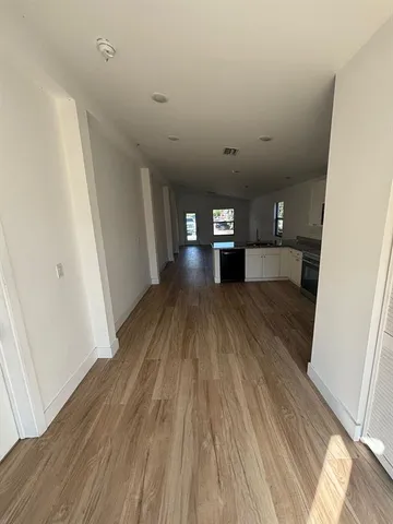 a view of a hallway with wooden floor