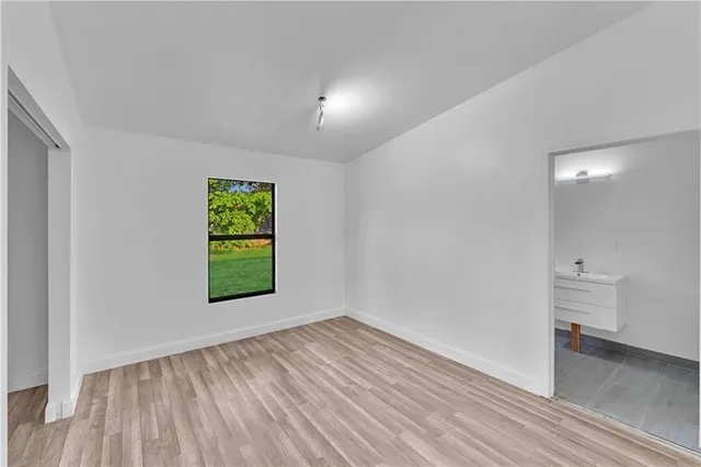 an empty room with windows and entrance