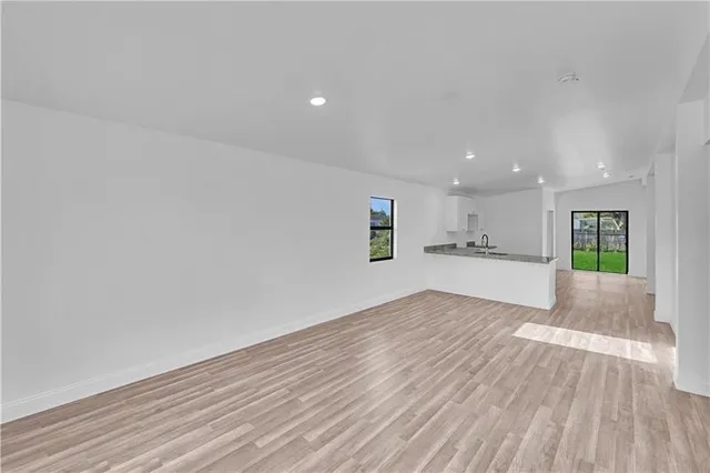 a view of kitchen and hall with wooden floor