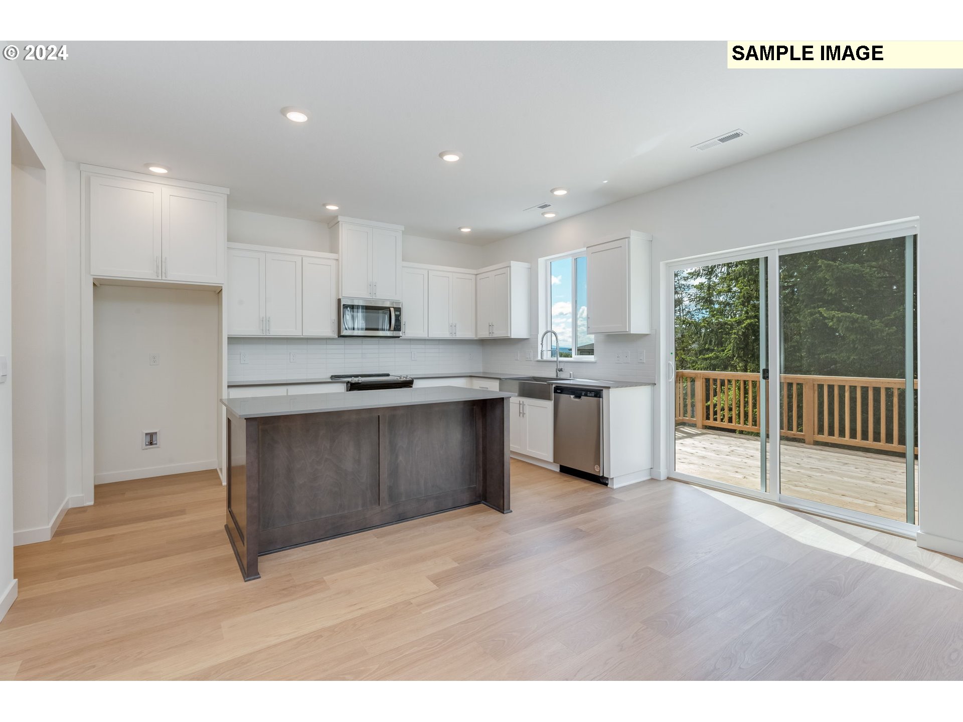 1120 West 15th Street La Center, WA 98629 - Photo 11 of 38 a kitchen with stainless steel appliances granite countertop a stove a sink and a refrigerator