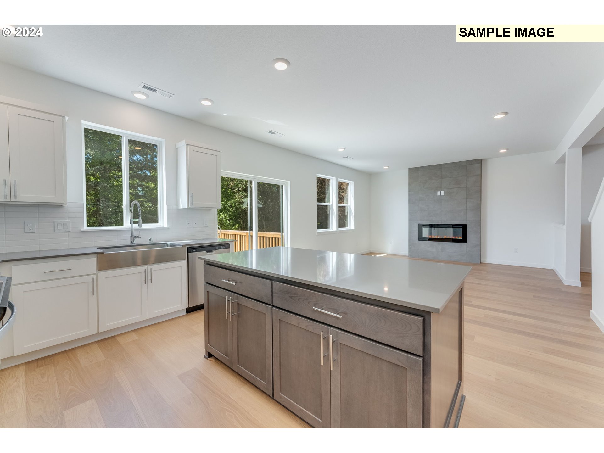 1120 West 15th Street La Center, WA 98629 - Photo 12 of 38 a kitchen with granite countertop a sink cabinets and wooden floor