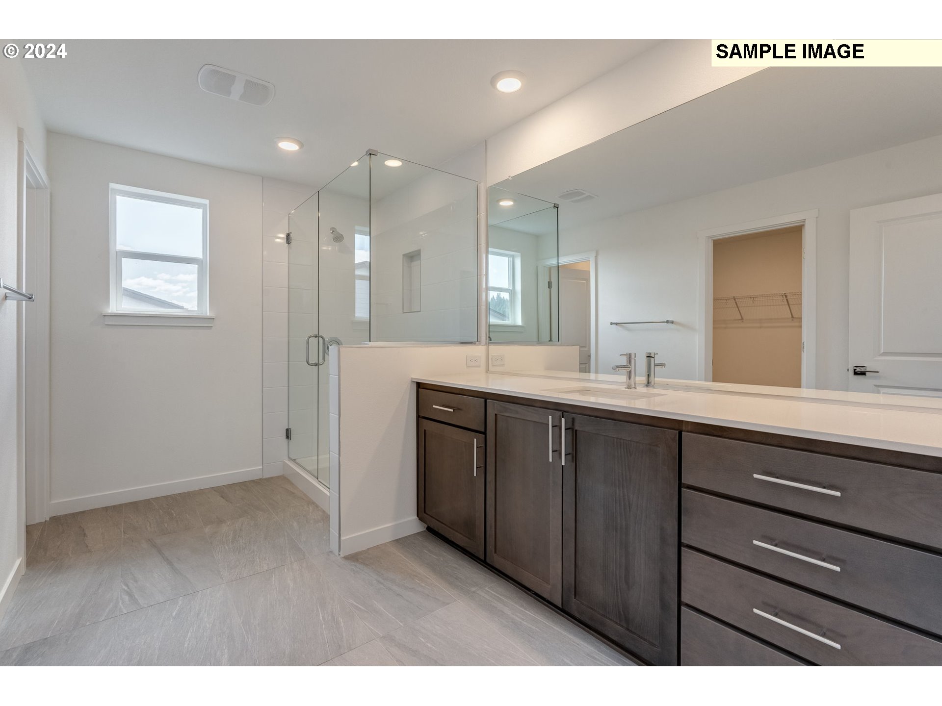 1120 West 15th Street La Center, WA 98629 - Photo 30 of 38 a bathroom with a double vanity sink and mirror