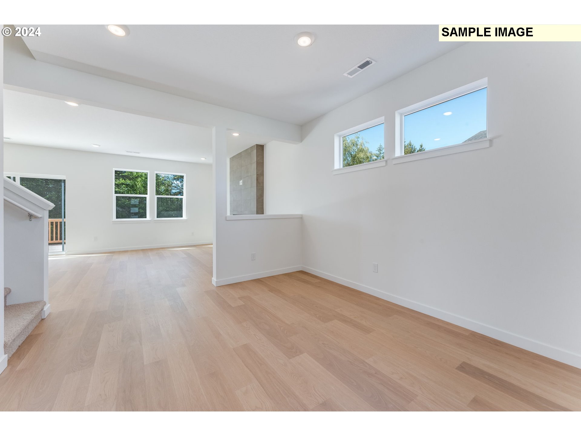 1120 West 15th Street La Center, WA 98629 - Photo 4 of 38 a view of an empty room with wooden floor and a window