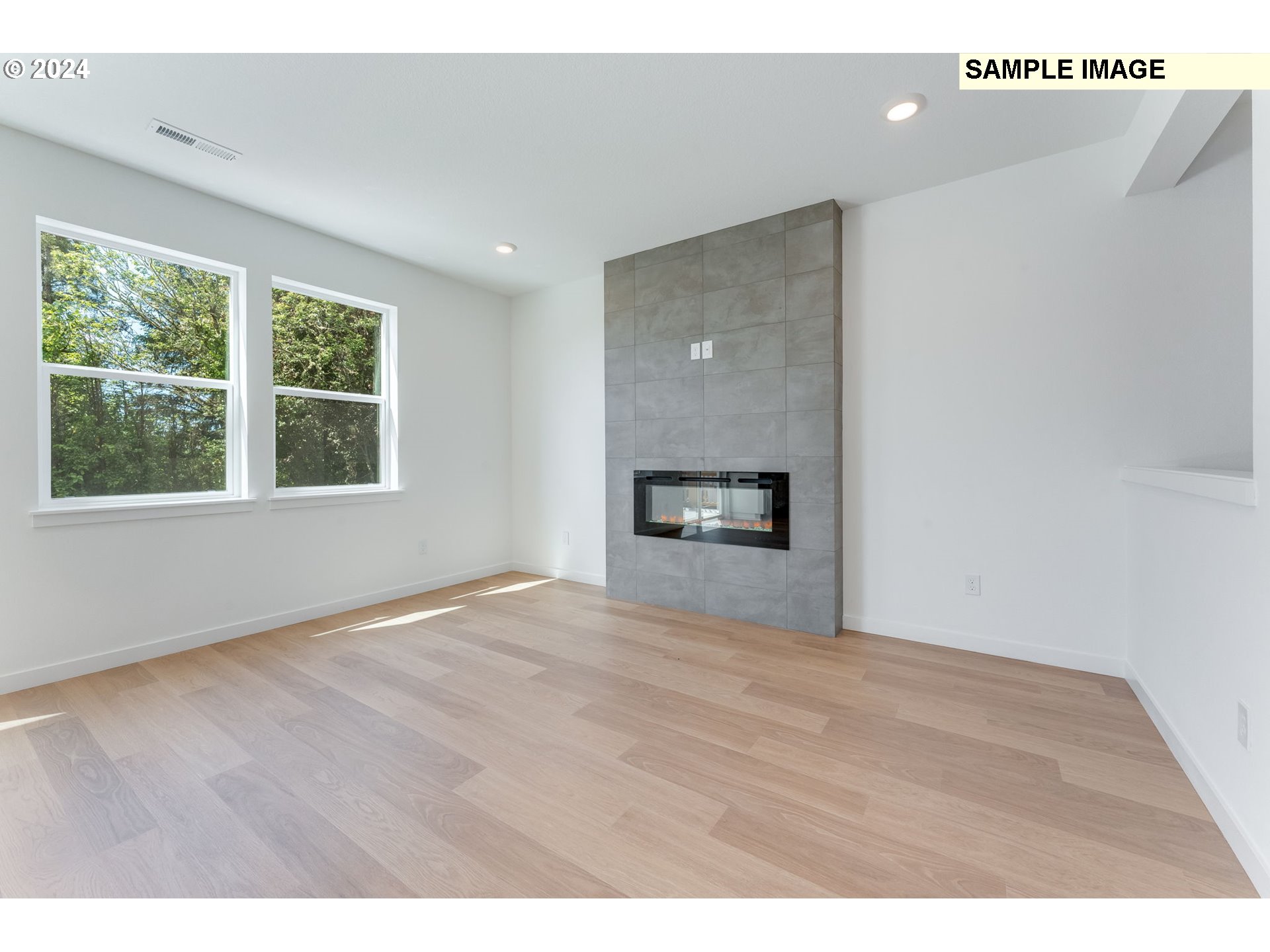 1120 West 15th Street La Center, WA 98629 - Photo 6 of 38 a view of an empty room with a window and a fireplace