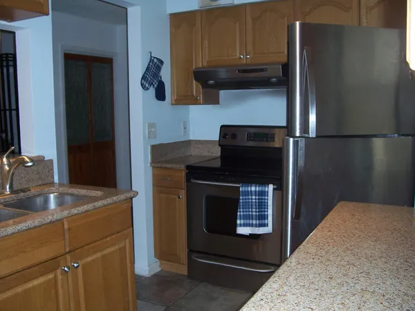 a kitchen with a sink and a refrigerator