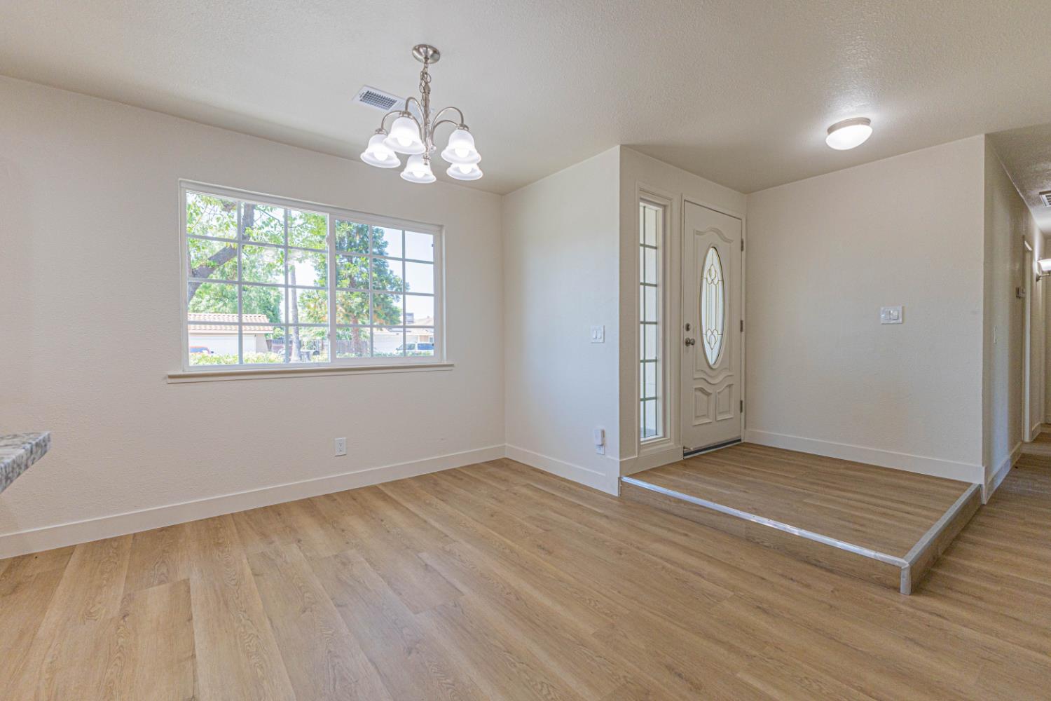17925 Rodeo Drive Madera, CA 93638 - Photo 6 of 26 a view of an empty room with wooden floor and a window