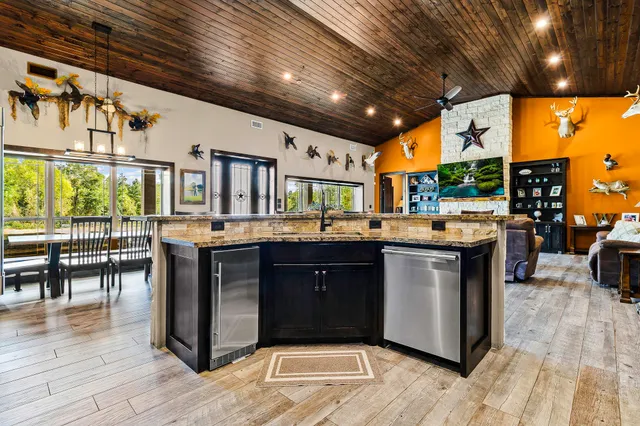 a view of a kitchen with furniture and wooden floor